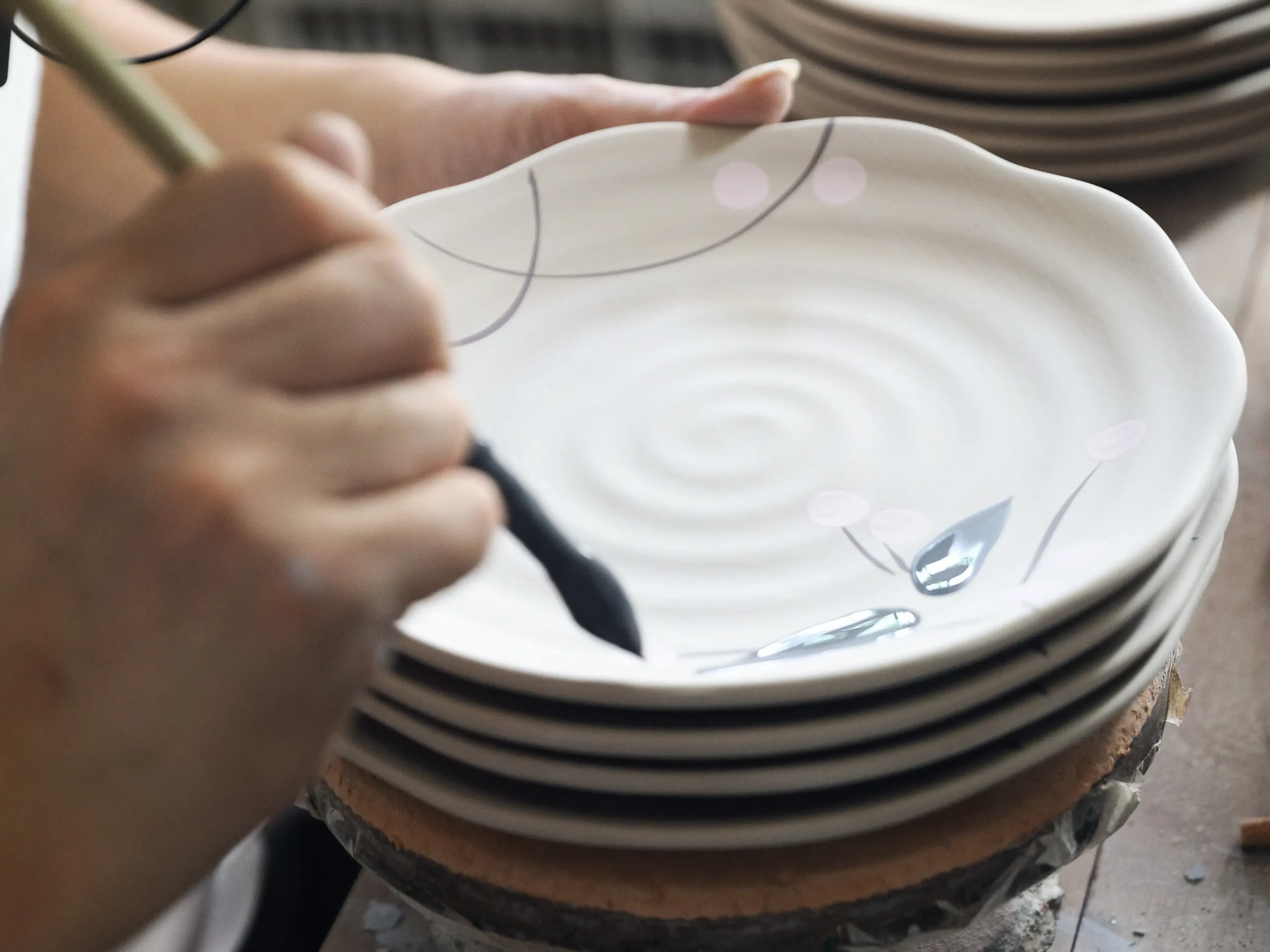 Artisan crafting ceramic tableware in FENN workshop